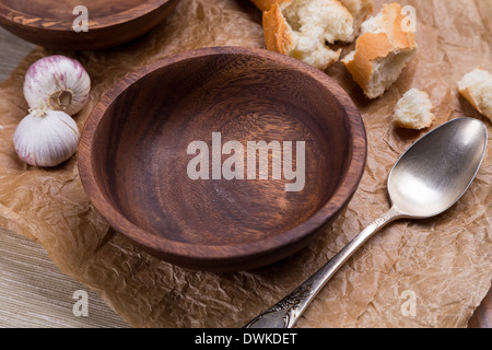 empty wooden bowl for soup on crushed brown paper Stock Photo
