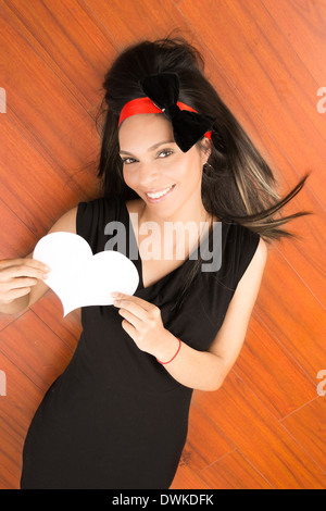 portrait of a pretty woman holding a white paper heart Stock Photo