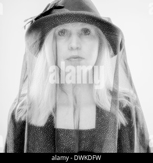 Widow, mature woman wearing black costume and veil, studio shot Stock Photo