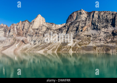 Reflections on a calm sea of the steep cliffs of Icy Arm, Baffin Island, Nunavut, Canada, North America Stock Photo