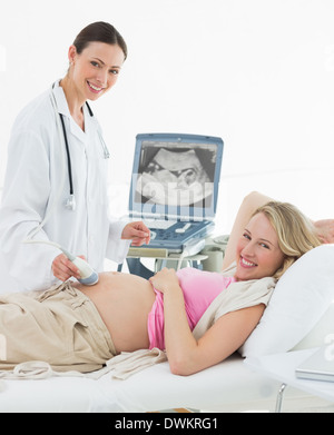 Doctor using ultrasound scanner on pregnant woman Stock Photo