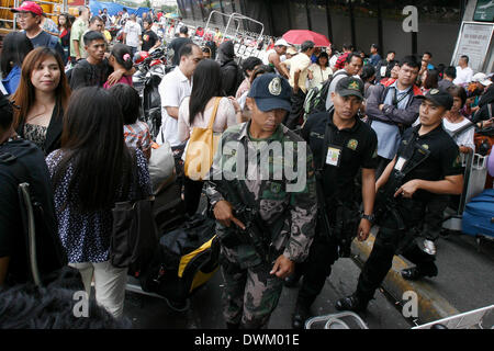 Manila, Philippines. 11th Mar, 2014. Members of the Aviation Security Group of the Philippine National Police (PNP) patrol at the Ninoy Aquino International Airport (NAIA) in Pasay City, the Philippines, March 11, 2014. © Rouelle Umali/Xinhua/Alamy Live News Stock Photo