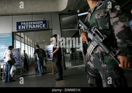 Manila, Philippines. 11th Mar, 2014. Members of the Aviation Security Group of the Philippine National Police (PNP) patrol at the Ninoy Aquino International Airport (NAIA) in Pasay City, the Philippines, March 11, 2014. © Rouelle Umali/Xinhua/Alamy Live News Stock Photo