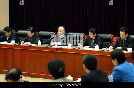 (140311) -- BEIJING, March 11, 2014 (Xinhua) -- Wang Qishan (C rear), a member of the Standing Committee of the Political Bureau of the Communist Party of China (CPC) Central Committee and secretary of the CPC Central Commission for Discipline Inspection, joins a discussion with deputies to the 12th National People's Congress (NPC) from southwest China's Sichuan Province during the second session of the 12th NPC, in Beijing, capital of China, March 11, 2014. (Xinhua/Yao Dawei) (zkr) Stock Photo