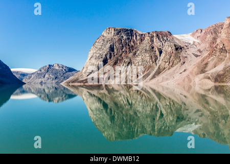Reflections on a calm sea of the steep cliffs of Icy Arm, Baffin Island, Nunavut, Canada, North America Stock Photo
