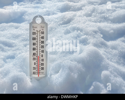 Ice cold thermometer in ice and snow to illustrate global warming, with space on the right for type Stock Photo