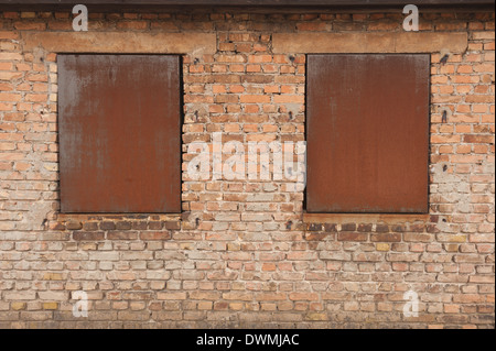Security windows blocked up with quarter inch steel plate or bricked in to prevent light and break Stock Photo