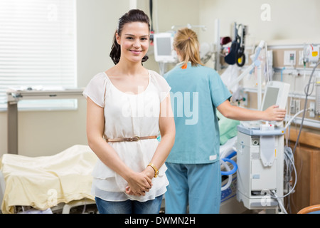 Woman With Nurse Examining Patient In Hospital Stock Photo