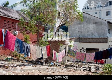 Washing hanging out to dry over derelict piece of land in Chiang Mai, Northern Thailand Stock Photo