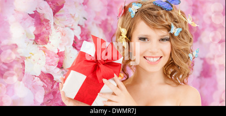 teenager with butterflies in hair showing present Stock Photo