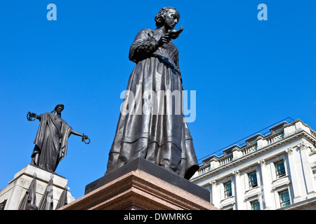 Florence Nightingale statue with the Crimean War Memorial behind. Situated in Waterloo Place in London. Stock Photo