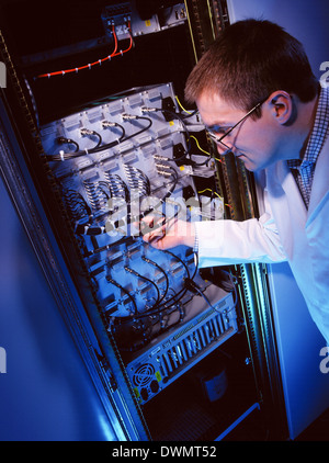 An IT technician working on a mainframe computer. Stock Photo
