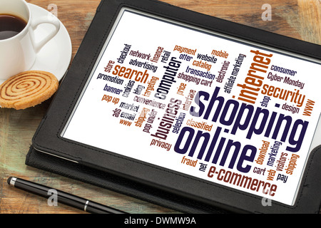 shopping online word cloud on a digital tablet with a cup of coffee Stock Photo