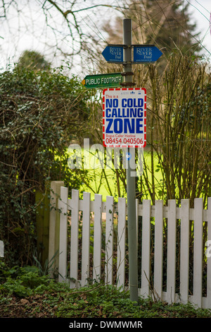 'No Cold Calling Zone' sign attached to a 'Public Footpath' signpost in a rural village in Bedfordshire, England, UK. Stock Photo