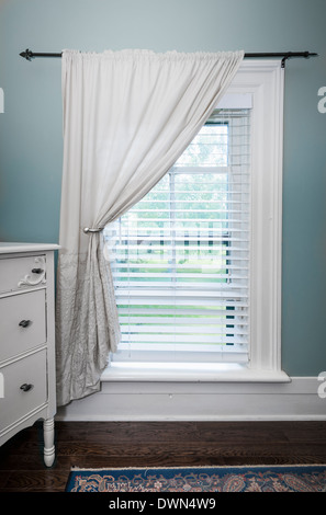 Window with venetian blinds and white curtain in country style room Stock Photo