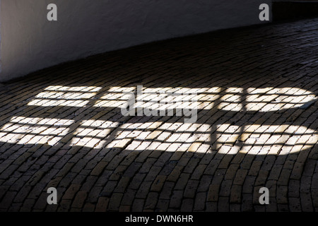 Harsh shadows through window arches Stock Photo