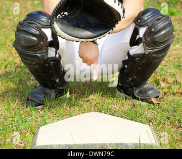 baseball catcher showing gesture for secret sign in field. Stock Photo