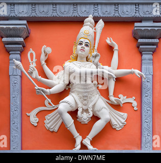 Nataraj Dancing Form of Lord Shiva Hindu God Orange and White Statue on Temple Exterior Wall Relief Stock Photo