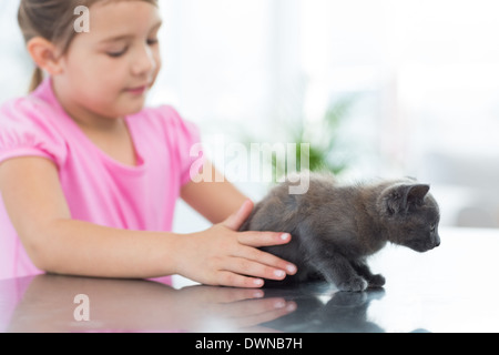 Girl playing with kitten Stock Photo