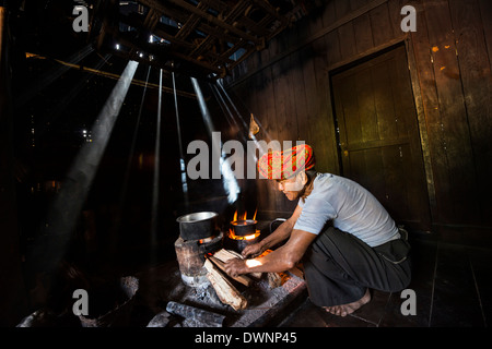 Elderly man at an open fire in the hut, Pa'O hill tribe, near Kalaw, Shan State, Myanmar Stock Photo