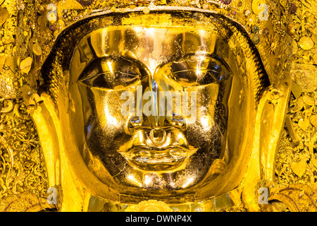 Golden seated Buddha, Mahamuni, face, Mandalay, Mandalay Division, Myanmar or Burma Stock Photo