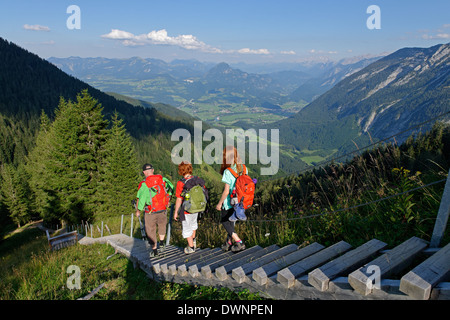 Hikers walking down the stairway leading to the Purtschellerhaus mountain hut on Hoher Göll mountain, Bayerischer Weg trail Stock Photo