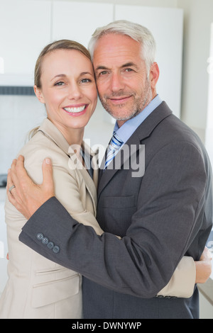 Happy business couple hugging each other before work in morning Stock Photo