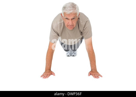 Portrait of a senior man doing push ups Stock Photo