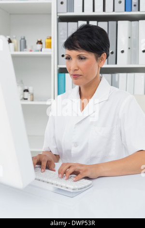 Concentrated female doctor using computer Stock Photo