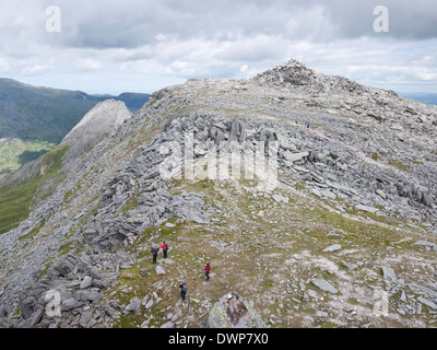 Hill walkers near the summit rock pile of Glyder Fach, in Snowdonia's Y Glyderau mountains Stock Photo