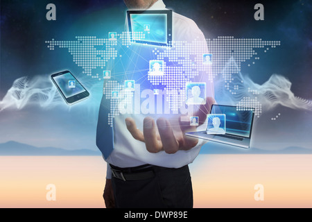 Businessman presenting earth interface with connecting devices Stock Photo