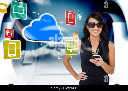 Glamorous brunette using smartphone with cloud and icons Stock Photo