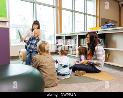 Teachers And Students In Library Stock Photo