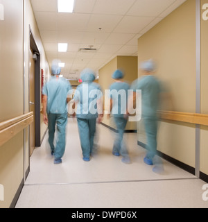 Medical Team Walking In Hospital Corridor Stock Photo