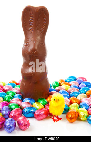 Milk chocolate easter bunny and colorful eggs over white background Stock Photo