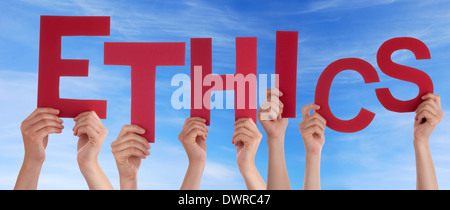 hands holding four pieces of a puzzle with copy space, gray background Stock Photo