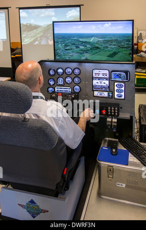 Man navigating virtual airplane in amateur flight simulator Stock Photo