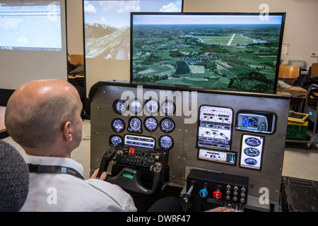 Man navigating virtual airplane in amateur flight simulator on home computer Stock Photo