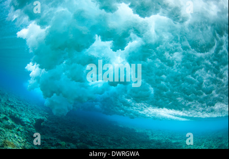 Unique underwater view of a wave breaking over a reef in the Maldives ...