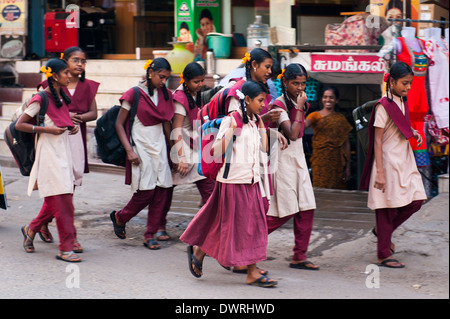 South Southern India Tamil Nadu Madurai street scene young schoolchildren schoolgirls school girls in uniform walking Stock Photo