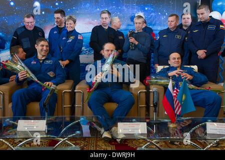 Karaganda airport, Kazakhstan. 11th March, 2014. International Space State Expedition 38 Mike Hopkins of NASA, left, Commander Oleg Kotov of the Russian Federal Space Agency, Roscosmos, center, and, Flight Engineer Sergey Ryazanskiy of Roscosmos during a welcoming ceremony after landing in a Soyuz TMA-10M spacecraft March 11, 2014 held at the Karaganda airport, Kazakhstan. Hopkins, Kotov and Ryazanskiy returned to Earth after five and a half months onboard the International Space Station. Credit:  Planetpix/Alamy Live News Stock Photo