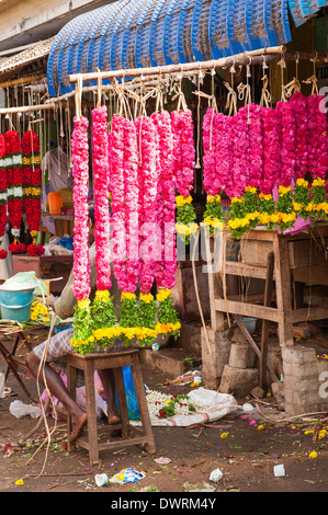 South Southern India Tamil Nadu Madurai flower market pink wedding garlands torans malas hang by stall Stock Photo