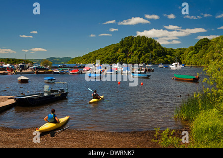 Kayaking at Balmaha Boatyard on Loch Lomond. Inchcailloch is in the background. Stock Photo