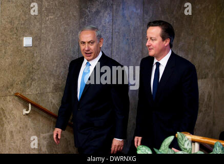 Jerusalem, Israel. 12th Mar, 2014. Israeli Prime Minister Benjamin Netanyahu (L) and British Prime Minister David Cameron walk to a news conference in Jerusalem March 12, 2014. David Cameron on Wednesday urged Israel to end Jewish settlement construction in the Israeli-occupied Palestinian lands. Credit:  POOL/Xinhua/Alamy Live News