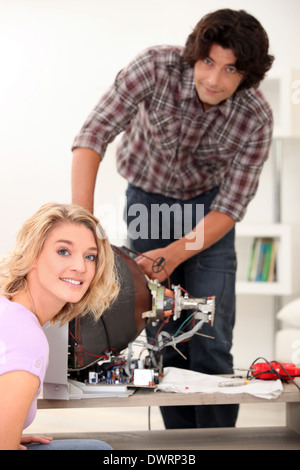 Couple repairing old television set Stock Photo