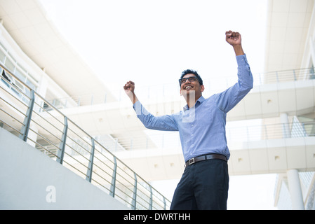 indian business male celebrating success with office background Stock Photo