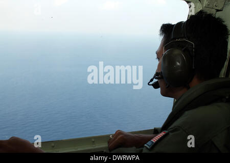 Kuala Lumpur. 13th Mar, 2014. A Malaysian air force soldier is seen during the search for the missing Malaysian Airlines flight, aboard C-130 transport aircraft March 13, 2014. The Malaysian air force Thursday morning sent an aircraft on an 8-hour search mission in areas around Subang, Penang, Phuket and Andaman Sea, but found no trace of the missing jetliner, the pilot of the mission said. Credit:  Xinhua/Alamy Live News Stock Photo