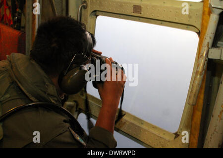 Kuala Lumpur. 13th Mar, 2014. A Malaysian air force soldier is seen during the search for the missing Malaysian Airlines flight, aboard C-130 transport aircraft March 13, 2014. The Malaysian air force Thursday morning sent an aircraft on an 8-hour search mission in areas around Subang, Penang, Phuket and Andaman Sea, but found no trace of the missing jetliner, the pilot of the mission said. Credit:  Xinhua/Alamy Live News Stock Photo