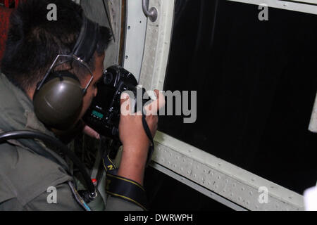 Kuala Lumpur. 13th Mar, 2014. A Malaysian air force soldier is seen during the search for the missing Malaysian Airlines flight, aboard C-130 transport aircraft March 13, 2014. The Malaysian air force Thursday morning sent an aircraft on an 8-hour search mission in areas around Subang, Penang, Phuket and Andaman Sea, but found no trace of the missing jetliner, the pilot of the mission said. Credit:  Xinhua/Alamy Live News Stock Photo