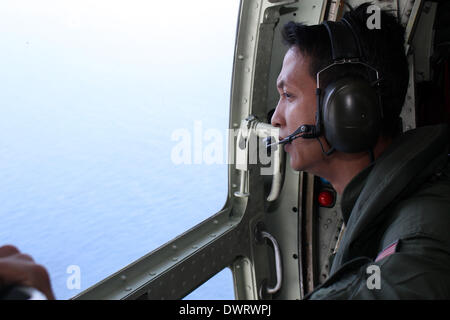 Kuala Lumpur. 13th Mar, 2014. A Malaysian air force soldier is seen during the search for the missing Malaysian Airlines flight, aboard C-130 transport aircraft March 13, 2014. The Malaysian air force Thursday morning sent an aircraft on an 8-hour search mission in areas around Subang, Penang, Phuket and Andaman Sea, but found no trace of the missing jetliner, the pilot of the mission said. Credit:  Xinhua/Alamy Live News Stock Photo